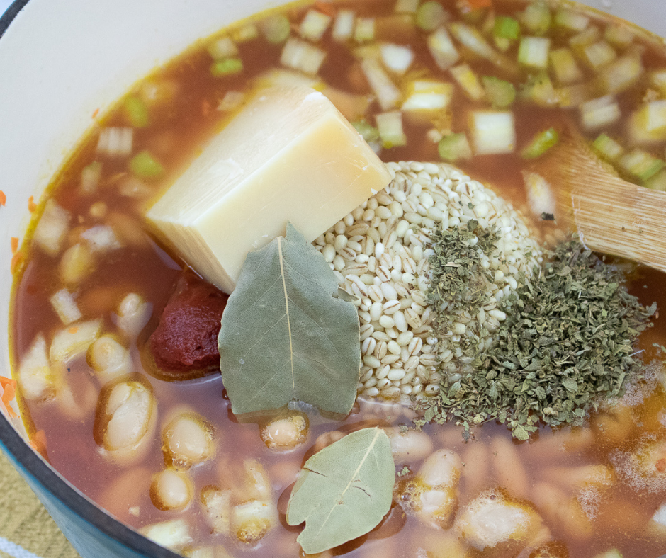 Ingredients being added to a Minestrone soup as it is being prepared