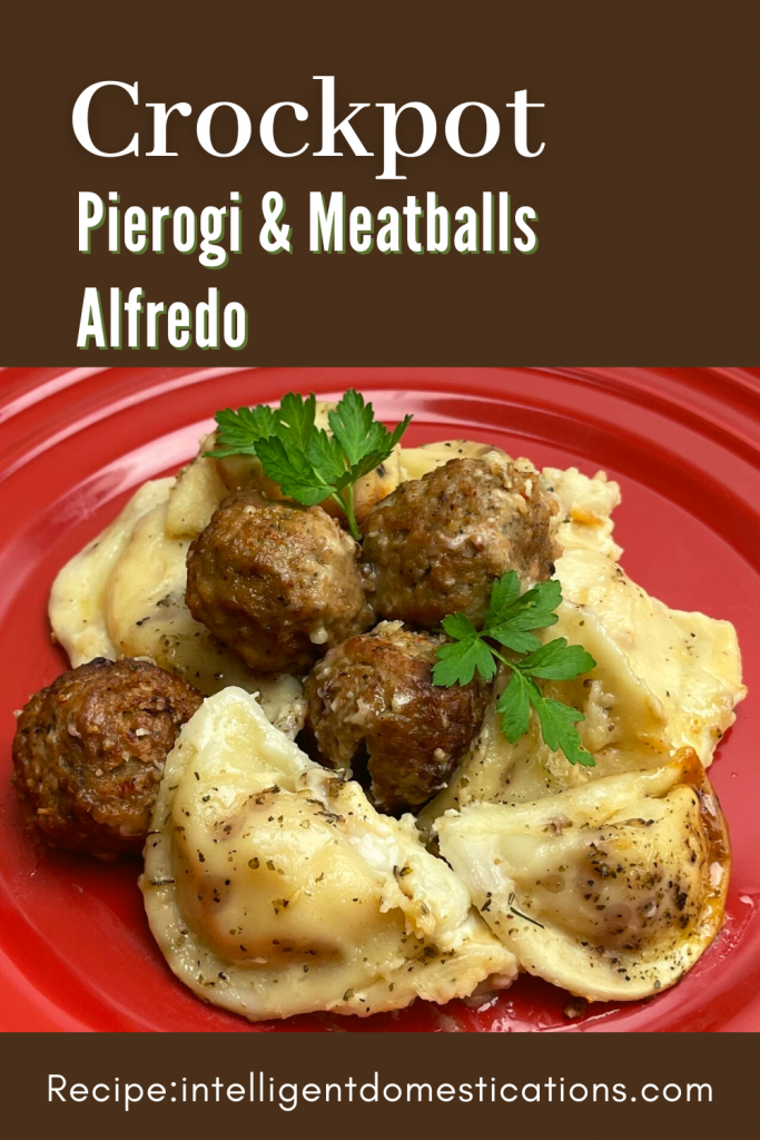 Pierogi's and meatballs on a red dish with alfredo sauce