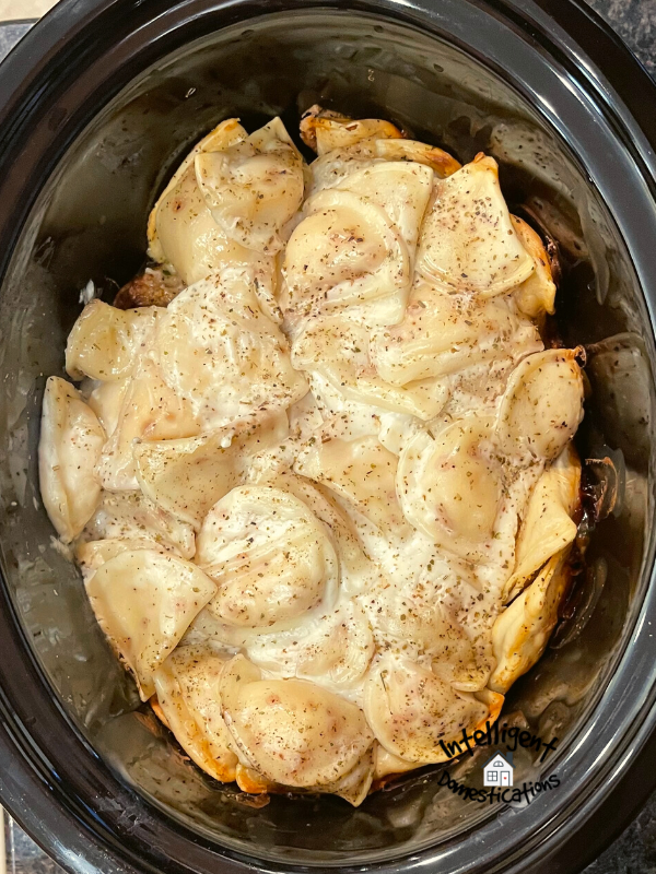Pierogies in the Crockpot on top of meatballs