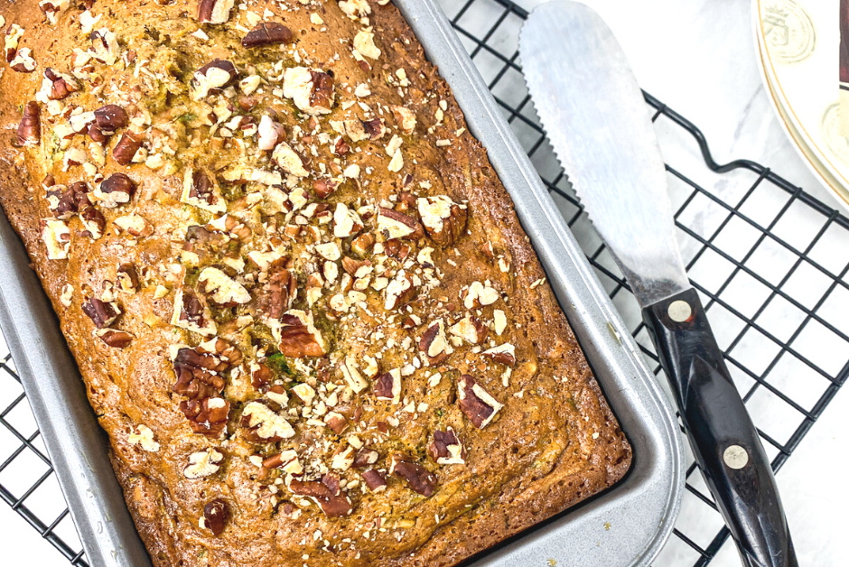 Pecan Zucchini Loaf on a cooling rack in the pan