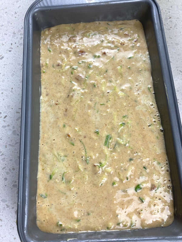 zucchini bread batter in a loaf pan