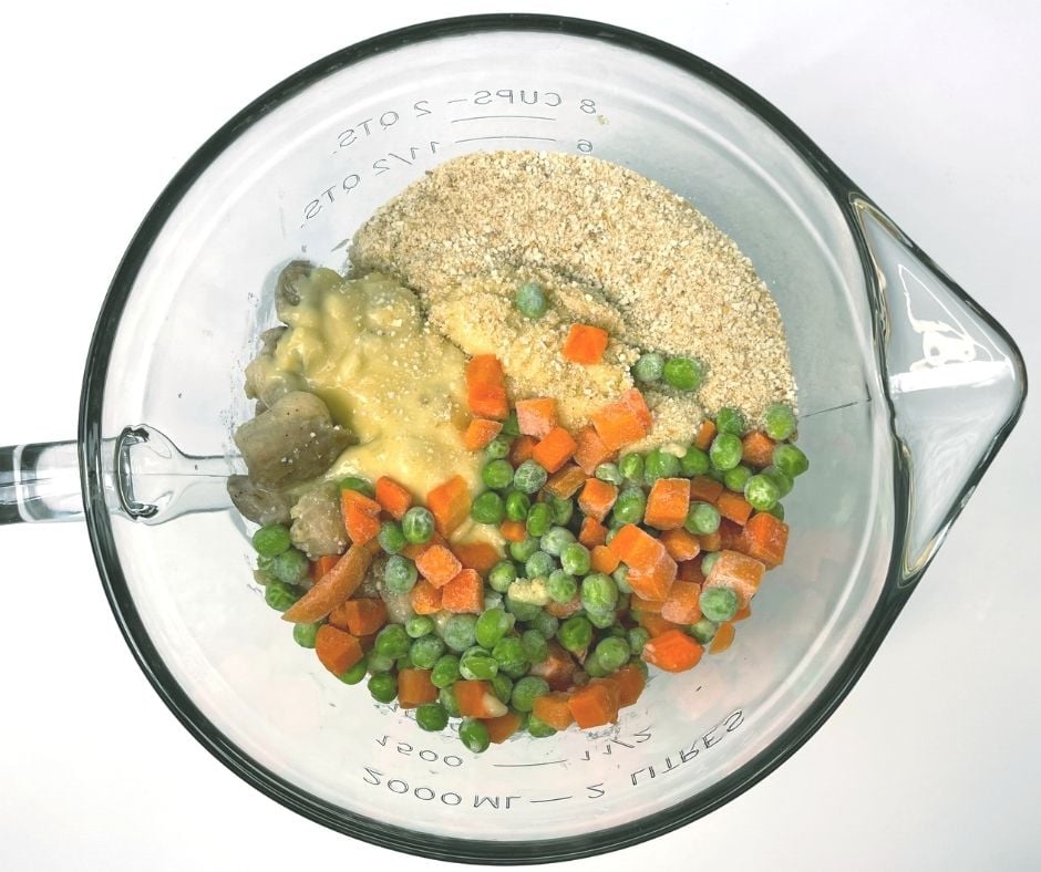 All ingredients of chicken casserole in large mixing bowl