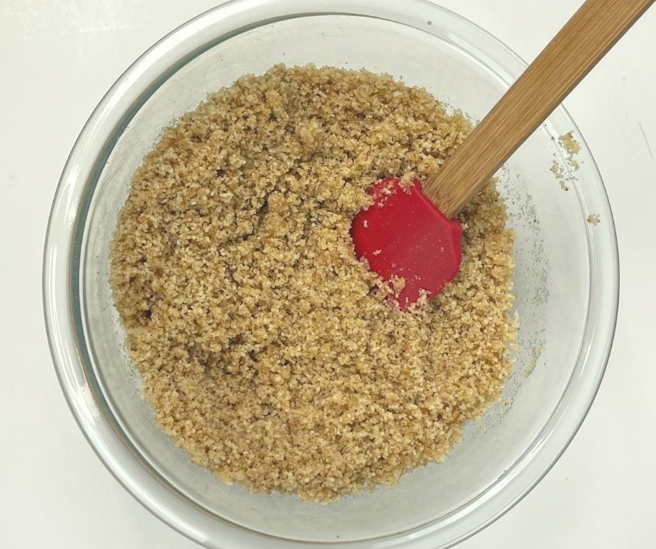bread crumbs and butter mixed together in a medium bowl