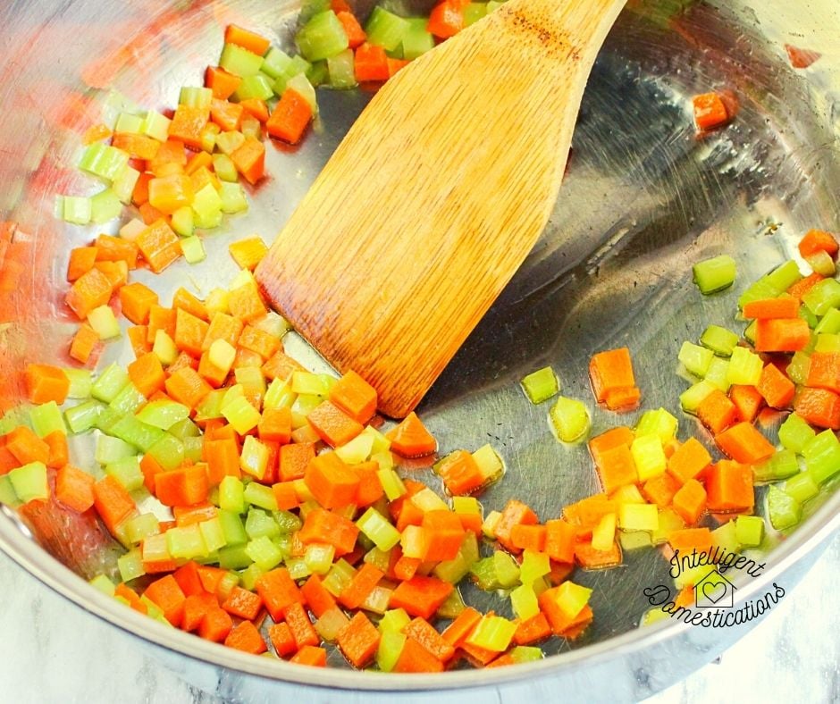 cubed carrots and celery cooking in a skillet
