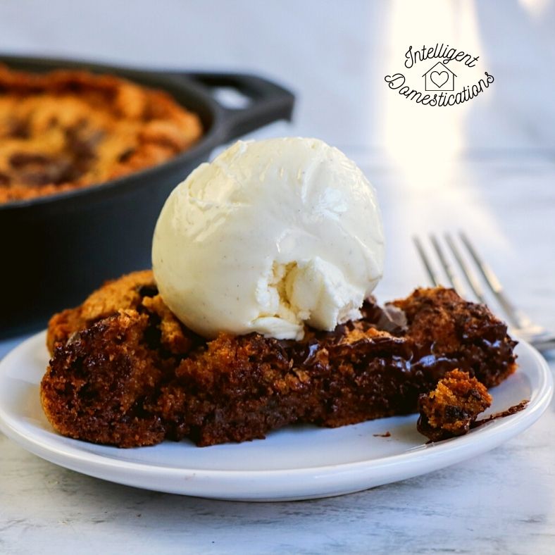 Chocolate Chip Skillet Cookies with Ice cream on top on a white plate