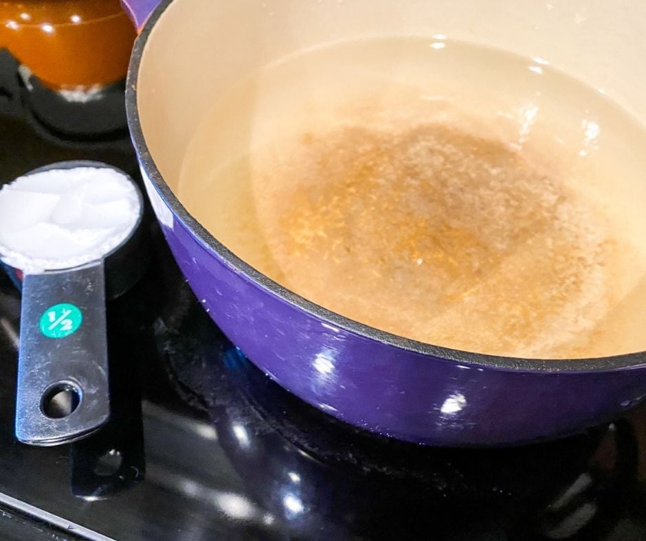 Boiling water in a pot to add baking soda