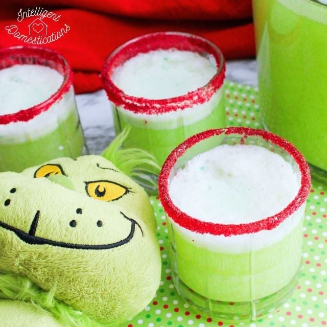 Green punch is clear glasses with red sugar on the rim and a Grinch doll