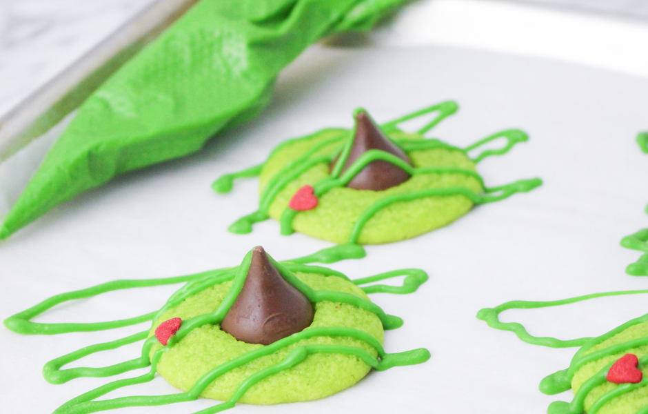 Grinch Blossom Cookies with green icing drizzle