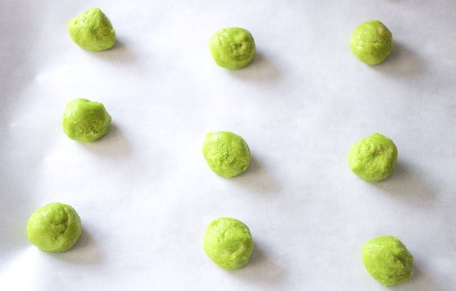 green cookie dough in balls on cookie sheet