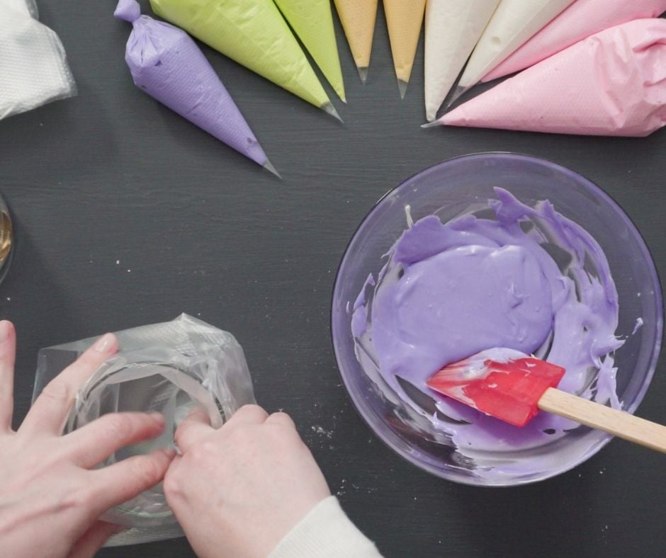 filling a piping bag with colored icing