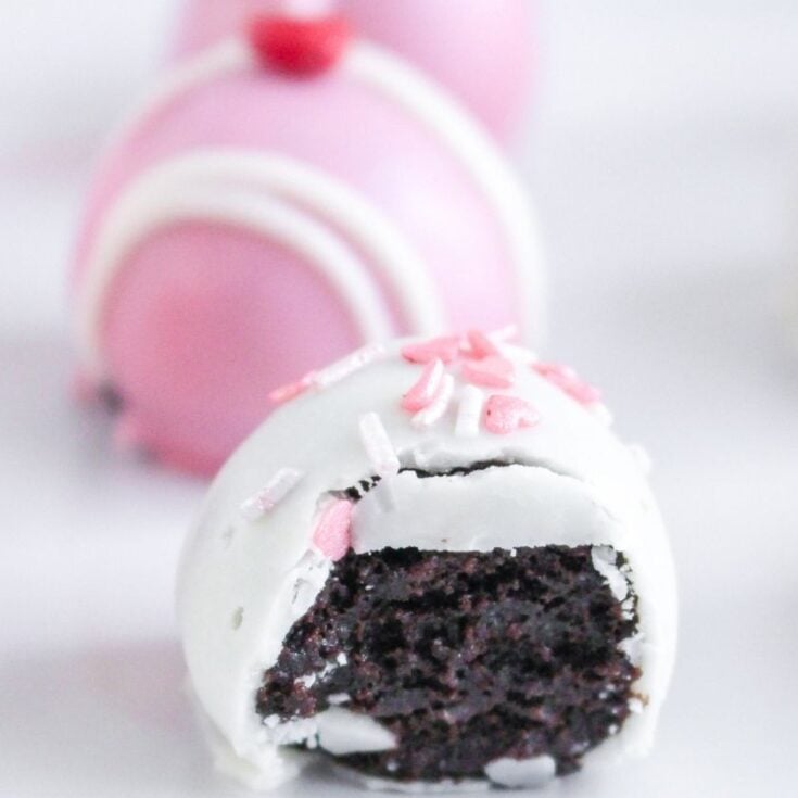 Oreo cookie truffle coated in white chocolate and decorated with pink sprinkles