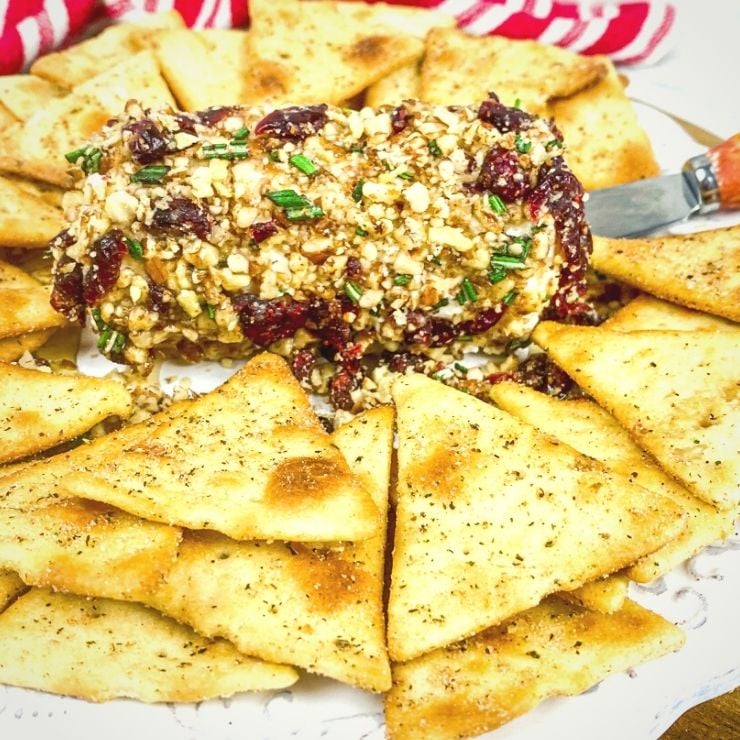 Cranberry Pecan Goat Cheese Log Appetizer on a dish with crackers
