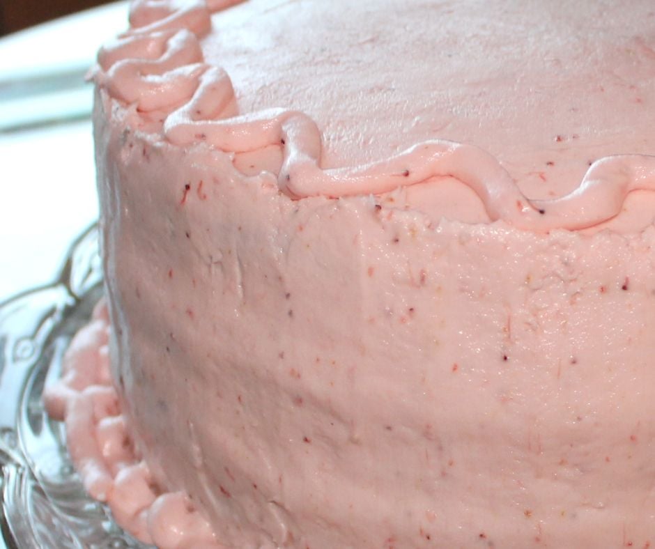 A close up view of Strawberry Buttercream frosting on a Strawberry Cake