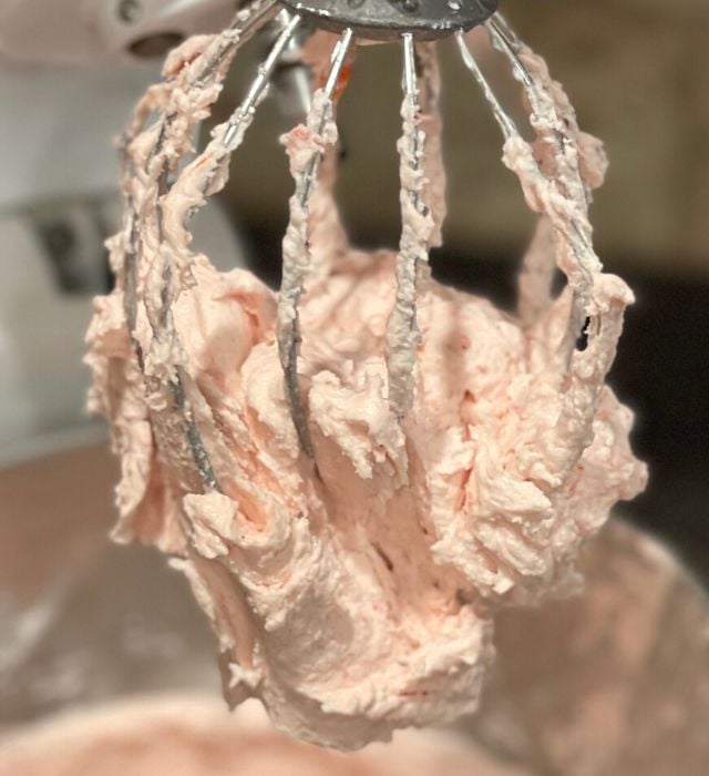 Thick Strawberry Buttercream frosting clinging to a beater