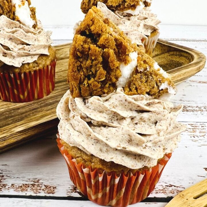 Oatmeal Cream Pie Cupcakes frosted with a wedge of an oatmeal cream pie cookie on top