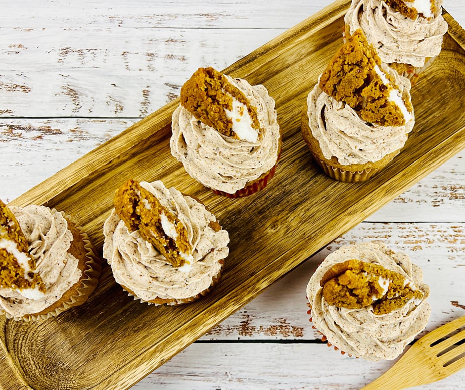 overhead view of Oatmeal cream pie frosted cupcakes on a wood serving tray