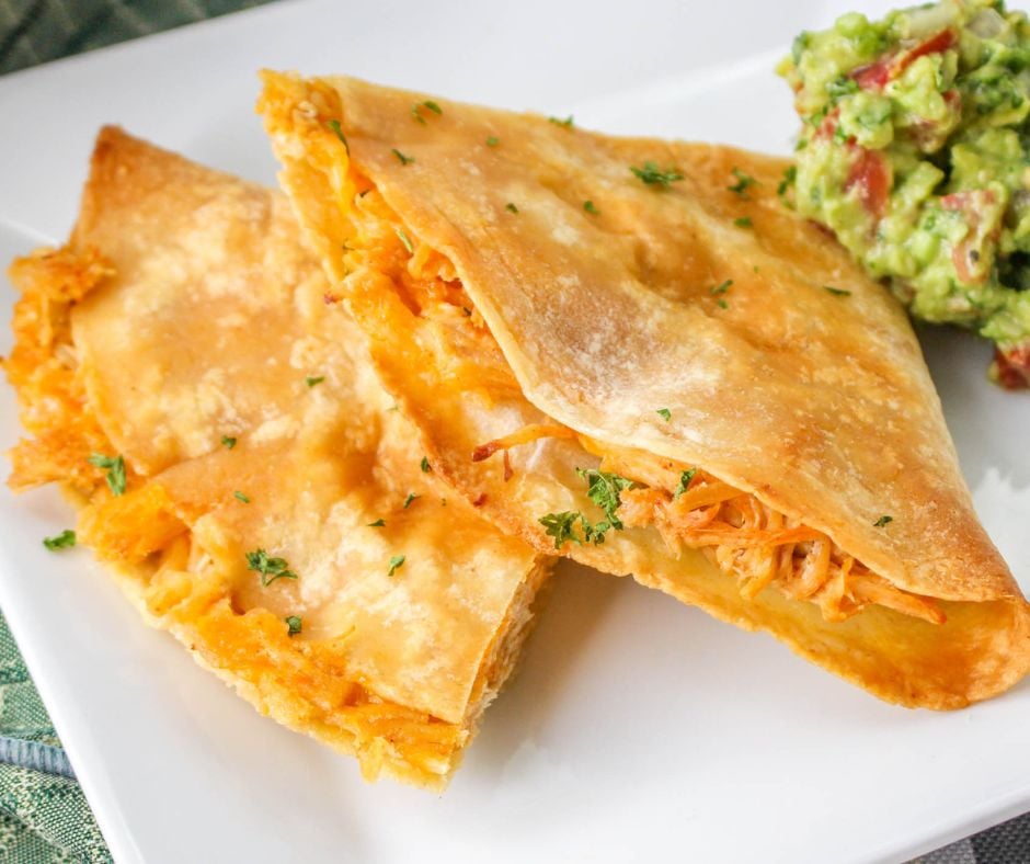 Baked Chicken Quesadillas on a white dish with guacamole