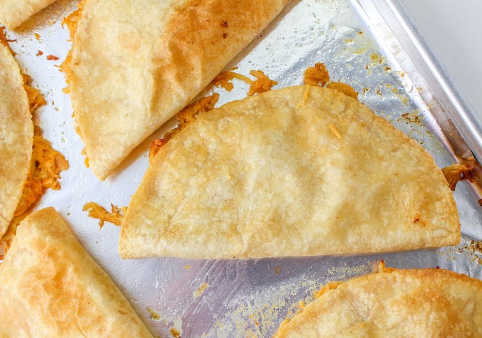 Oven baked chicken and cheese quesadillas on a baking sheet