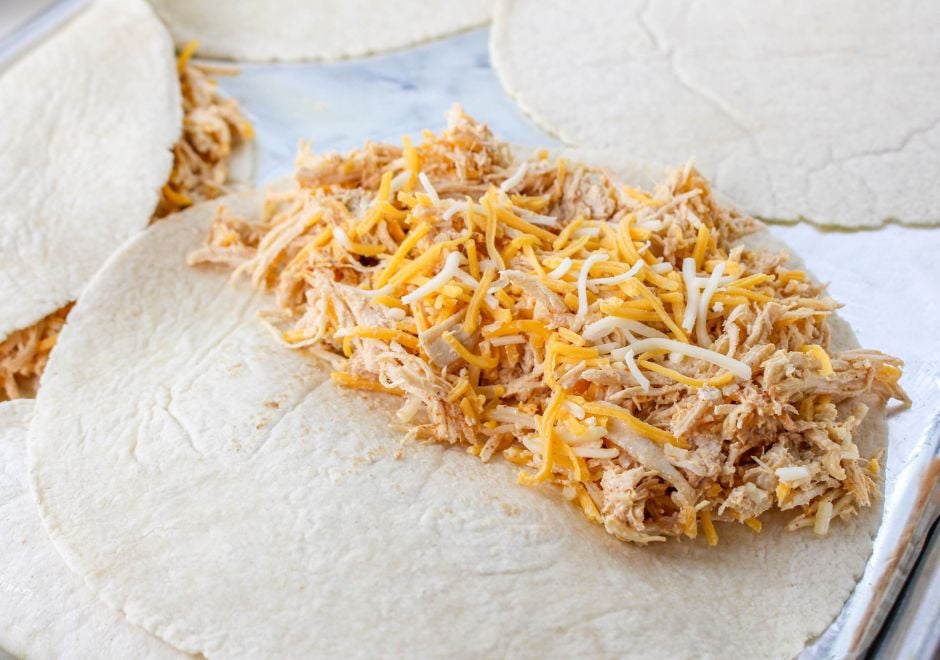 Pile the chicken and cheese quesadilla filling onto the tortilla shells