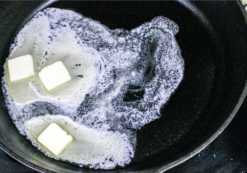 butter melting in an iron skillet