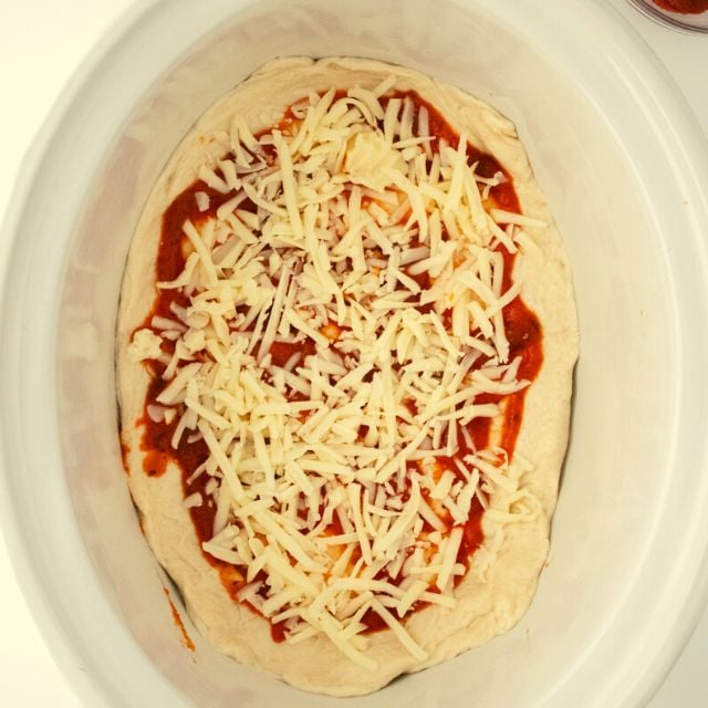 spread the pizza sauce and cheese onto the pizza dough