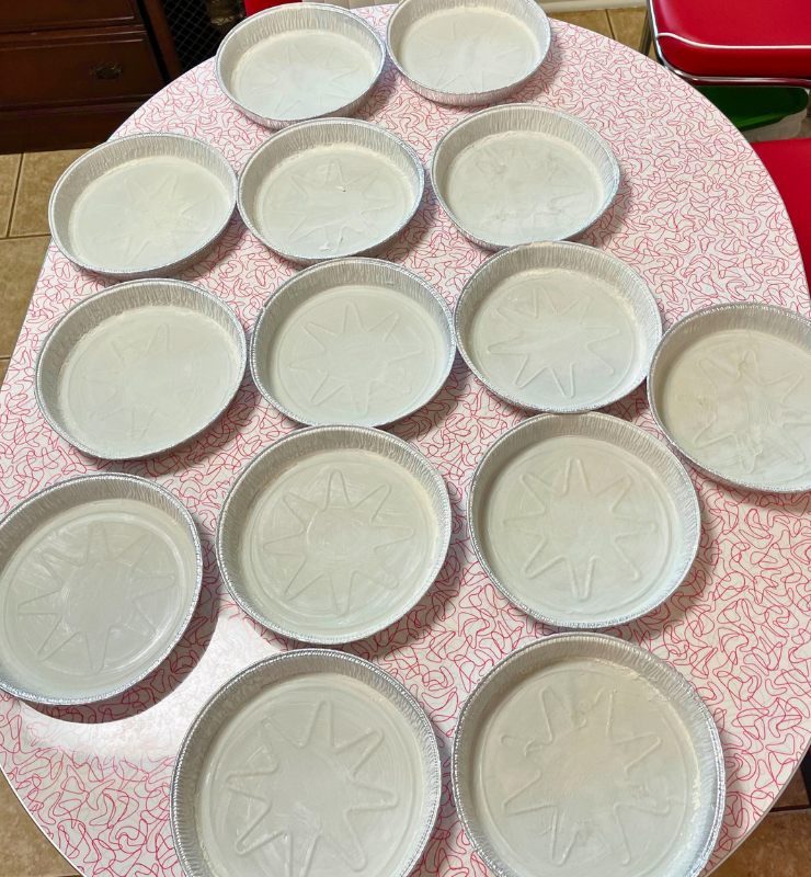 14 cake pans greased and floured and ready for cake batter