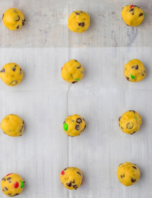 Christmas Chocolate Chip cookie dough balls on a baking sheet ready for the oven
