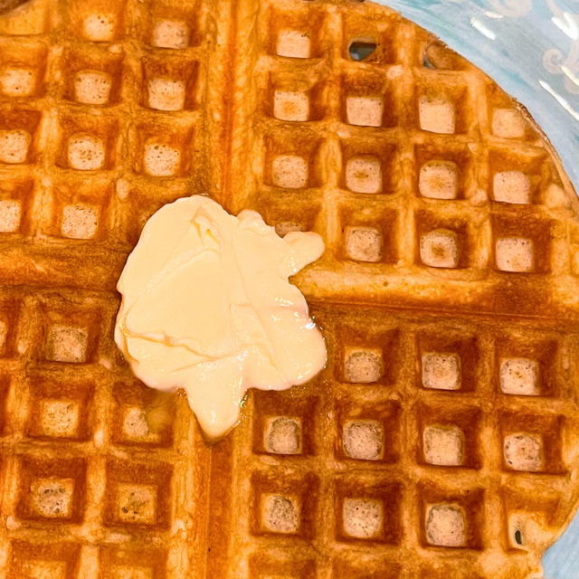 Golden brown waffle with melting butter on top