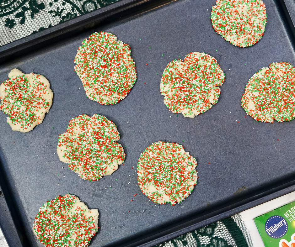 sugar cookies with sprinkles on a baking pan