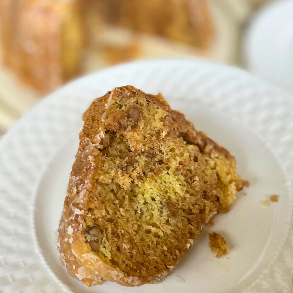 a slice of Honey Bun Bundt cake on a white dessert dish