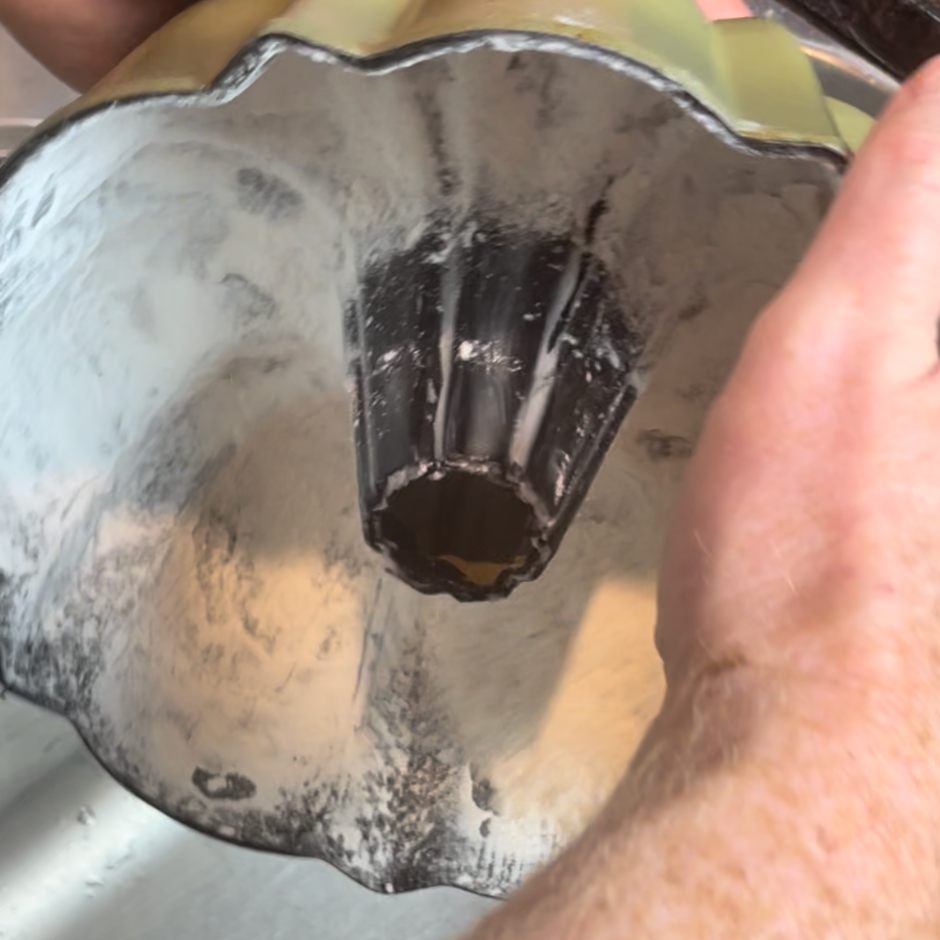 tapping flour into a greased cake pan