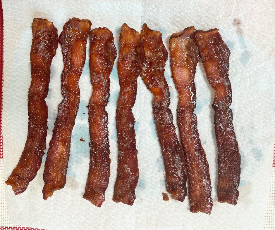 crispy cooked bacon on a paper towel covered plate