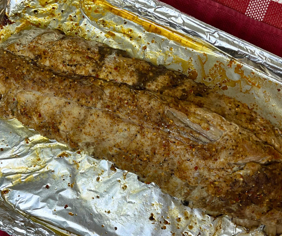 oven baked ribs fresh from the oven ready to be basted with BBQ sauce