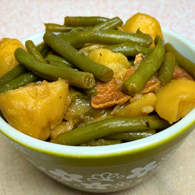 Green beans and potatoes with bacon served in a bowl