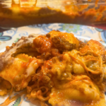 A serving of Cheesy Baked Ravioli on a dinner plate